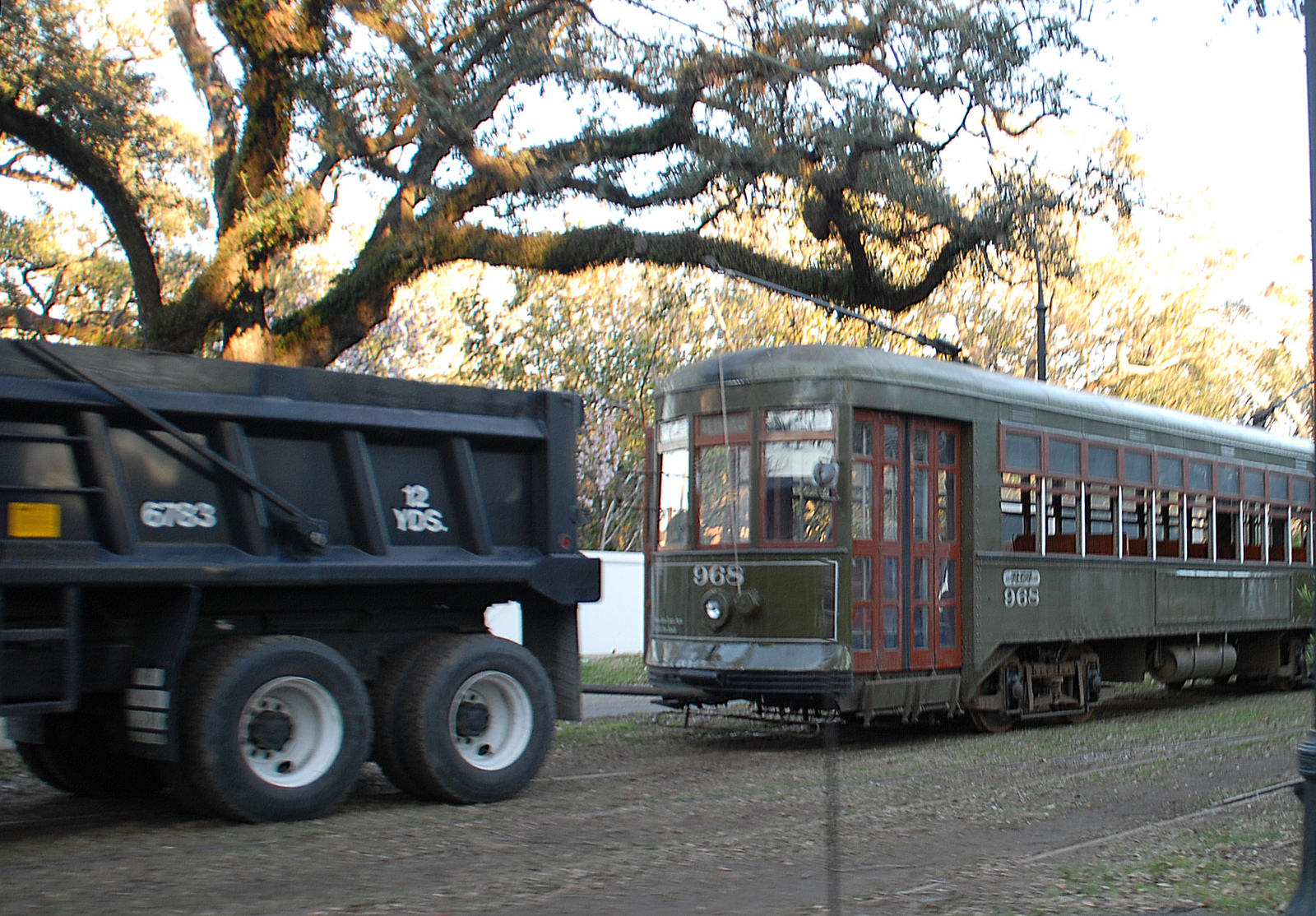 Streetcar being pulled by a transit worker truck, no electric power, repairing new orleans tracks and lines Hurricane Katrina